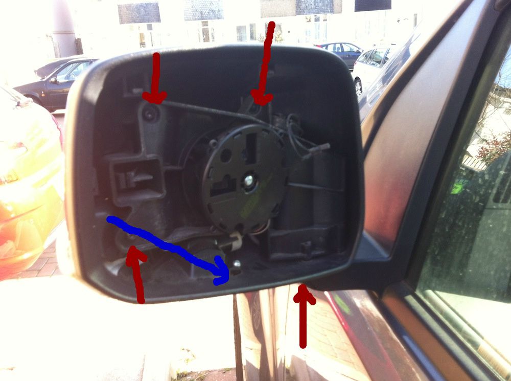 How do you remove the indicator lens in the mirror?